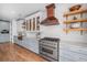 Modern kitchen with copper accents, stainless steel appliances, and marble countertops at 3920 Maybreeze Rd, Marietta, GA 30066