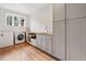 Functional laundry room features built-in cabinets, a sink, and modern washer and dryer at 3920 Maybreeze Rd, Marietta, GA 30066