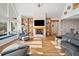 Spacious living room with large windows, fireplace, built-in shelves and hardwood floors at 3920 Maybreeze Rd, Marietta, GA 30066