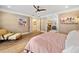 Bright and airy main bedroom features hardwood floors, a comfortable armchair and backyard views at 3920 Maybreeze Rd, Marietta, GA 30066