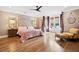 Luxurious main bedroom features hardwood floors, a decorative ceiling fan, and access to the backyard at 3920 Maybreeze Rd, Marietta, GA 30066