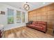 Office featuring a leather sofa, paneled accent wall, and three large windows at 3920 Maybreeze Rd, Marietta, GA 30066