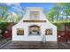 Outdoor fireplace with wood storage on a private patio and view of the landscaped yard at 3920 Maybreeze Rd, Marietta, GA 30066