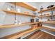 Well-organized pantry features wooden shelves and hardwood floors, providing ample storage space at 3920 Maybreeze Rd, Marietta, GA 30066