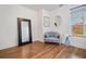 Bright sitting room with wood floors, a blue couch, and a large window at 3920 Maybreeze Rd, Marietta, GA 30066