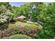 A secluded backyard featuring colorful azaleas and lush landscaping, creating a private oasis for relaxation and enjoyment at 272 Rumson Ne Rd, Atlanta, GA 30305