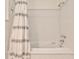 Clean white bathroom with a tub, shower, and classic tile work at 272 Rumson Ne Rd, Atlanta, GA 30305