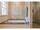 Luxurious bathroom with a soaking tub, separate shower, and elegant tile work, creating a relaxing retreat at 272 Rumson Ne Rd, Atlanta, GA 30305