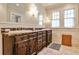 Elegant bathroom featuring dual sinks, marble countertops, and wood cabinetry for a spa-like experience at 272 Rumson Ne Rd, Atlanta, GA 30305