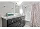 Bathroom featuring a modern vanity with black cabinets, a soaking tub and stylish watermelon shower curtain at 272 Rumson Ne Rd, Atlanta, GA 30305