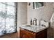Cozy bathroom with patterned wallpaper, marble sink, and patterned window shade at 272 Rumson Ne Rd, Atlanta, GA 30305