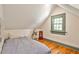 Cozy bedroom with hardwood floors, a pitched ceiling, and a large window providing natural light at 272 Rumson Ne Rd, Atlanta, GA 30305
