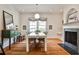 Bright dining room features hardwood floors, a fireplace, a large mirror, and a white table at 272 Rumson Ne Rd, Atlanta, GA 30305