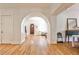 Inviting entryway with hardwood floors, arched doorway, and natural light, creating a warm and welcoming ambiance at 272 Rumson Ne Rd, Atlanta, GA 30305