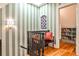 Hallway with stylish striped wallpaper, stained glass window and access to a cozy book nook at 272 Rumson Ne Rd, Atlanta, GA 30305