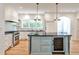 Kitchen with island, modern appliances, stone countertops, and open shelving with light hardwood flooring at 272 Rumson Ne Rd, Atlanta, GA 30305