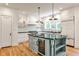 Modern kitchen with island, stainless steel appliances, hardwood floors, and black countertops at 272 Rumson Ne Rd, Atlanta, GA 30305