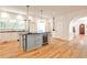 Bright kitchen features a light gray island with a wine fridge, hardwood floors, and lots of storage at 272 Rumson Ne Rd, Atlanta, GA 30305