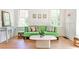 Bright living room with hardwood floors, complemented by a stylish green sofa and an abundance of natural light at 272 Rumson Ne Rd, Atlanta, GA 30305