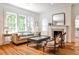 Cozy living room with hardwood floors, a fireplace, and large windows, creating a bright and inviting atmosphere at 272 Rumson Ne Rd, Atlanta, GA 30305