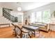 Inviting living room with hardwood floors, staircase, and large windows that bring in natural light at 272 Rumson Ne Rd, Atlanta, GA 30305