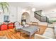 Spacious living room with hardwood floors, classic archway, a staircase, and stylish furniture at 272 Rumson Ne Rd, Atlanta, GA 30305