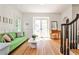 Open-concept living room with hardwood floors, a cozy green sofa, and stairs, creating a spacious and inviting atmosphere at 272 Rumson Ne Rd, Atlanta, GA 30305