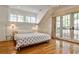 Serene main bedroom featuring hardwood floors, white walls, balcony access and plenty of natural light at 272 Rumson Ne Rd, Atlanta, GA 30305