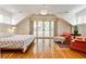Spacious main bedroom featuring hardwood floors, and a private french-door balcony with abundant natural light at 272 Rumson Ne Rd, Atlanta, GA 30305