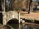 Stone bridge over water feature in serene landscape setting offers unique charm and appeal at 272 Rumson Ne Rd, Atlanta, GA 30305