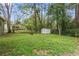 Large backyard featuring green grass, a firepit, and storage shed at 3048 Cottonwood Se Dr, Atlanta, GA 30316