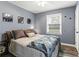 Bedroom featuring a large window, hardwood floors and a queen size bed at 3048 Cottonwood Se Dr, Atlanta, GA 30316