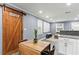 Modern dining area adjacent to the kitchen, featuring laundry barn door and a large projector screen at 3048 Cottonwood Se Dr, Atlanta, GA 30316