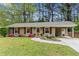 Charming single-story home with a landscaped yard, carport, and freshly painted facade at 3048 Cottonwood Se Dr, Atlanta, GA 30316