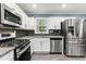 Modern kitchen with stainless steel appliances, granite countertops, and white cabinetry at 3048 Cottonwood Se Dr, Atlanta, GA 30316