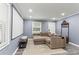 Comfortable living room with a large screen, projector, and a neutral-toned sectional sofa at 3048 Cottonwood Se Dr, Atlanta, GA 30316