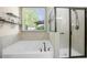 Bright bathroom showcasing a tub and a glass-enclosed shower with nice natural light at 3739 Union Park Dr, Duluth, GA 30097