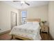 Cozy bedroom with wood floors, a ceiling fan, a quilt-covered bed, and bedside table at 3739 Union Park Dr, Duluth, GA 30097