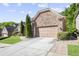 View of the stone and brick home with beautiful landscaping and a spacious driveway leading to a two-car garage at 3739 Union Park Dr, Duluth, GA 30097