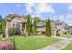 Landscaped front yard with brick and stone exterior, manicured lawn, and vibrant flower beds enhancing curb appeal at 3739 Union Park Dr, Duluth, GA 30097