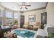 Elegant living room with bay window, ornate decor, ceiling fan, and hardwood floors offers a bright and airy feel at 3739 Union Park Dr, Duluth, GA 30097