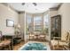 Bright living room with bay window, dark wood floors, and tastefully appointed furniture at 3739 Union Park Dr, Duluth, GA 30097
