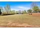 Large backyard with a lush lawn and a home featuring a covered porch at 541 Lombard St, Marietta, GA 30064