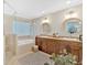 Spa-like bathroom with double vanity, soaking tub, and glass-enclosed shower at 541 Lombard St, Marietta, GA 30064