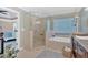 Bright bathroom featuring a glass shower, soaking tub, and a vanity with granite counters at 541 Lombard St, Marietta, GA 30064