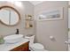 Charming powder room with round mirror, vessel sink, and decorative shelving at 541 Lombard St, Marietta, GA 30064