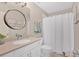 Clean bathroom featuring a granite countertop, white cabinets, and white shower curtain at 541 Lombard St, Marietta, GA 30064