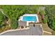 An aerial view showcases a neighborhood pool, surrounded by green trees, a parking area, and a small pool house at 541 Lombard St, Marietta, GA 30064