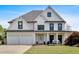 Charming two-story home with a manicured lawn and attached two car garage at 541 Lombard St, Marietta, GA 30064