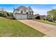 Spacious two-story home featuring a three-car garage, a welcoming porch, and a well-maintained green lawn at 541 Lombard St, Marietta, GA 30064